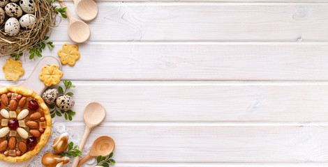 Easter background with  mazurek pastry and quail eggs on rustic white wooden background, top view, copy space. Traditional Easter 