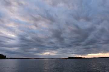 Stormy clouds and sunset over the water