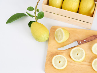 Lemon slide on wooden cutting board.