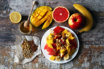 Fruit salad with honey and seeds. Healthy breakfast or snack. Vegan Dessert. Selective focus. Macro.