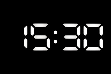 Real white led digital clock on black background
