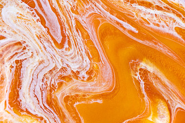 Burnt orange liquid and white foam mixing raster background. Colorful fluid splashes realistic...