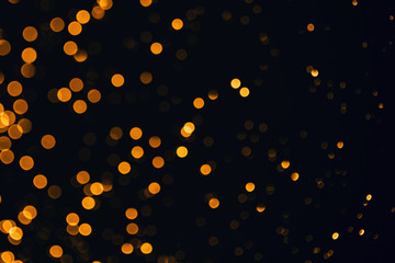 Fototapeta na wymiar Golden sparkles raster festive background. Bokeh lights with bright shiny effect illustration. Overlapping glowing and twinkling spots decorative backdrop. Abstract glittering circles.