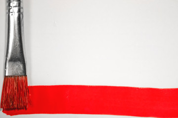 red paint brush on white aquarella background