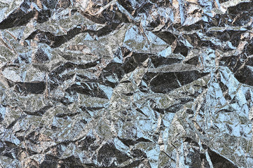 Thin sheet of silver aluminium foil texture background with shiny crumpled uneven surface
