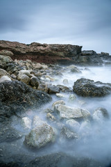 Mystical and magic moody long exposure shot, water seems like fog, of a mediterranean landscape of a rocky cove in Sa Rapita, Majorca, Balearic Islands, Spain. Inspirational aesthetics.