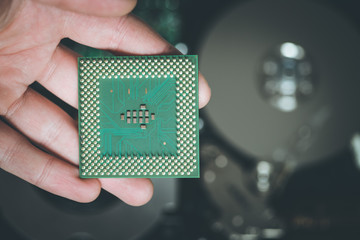 Computer Technology: Close up of male hands holding a cpu .
