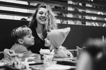 mom with kids at mcdonalds. Mom with children in a cafe.
