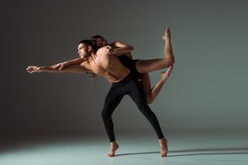 sexy dancers dancing contemporary on dark background with copy space