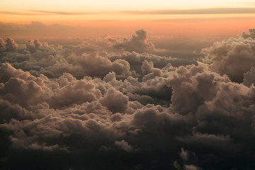 Aerial view of a dramatic sky with foamy clouds at sunset