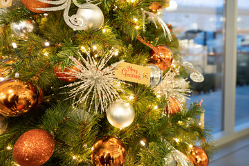 Closeup of bauble balls hanging from a decorated Christmas tree. christmas background concept.