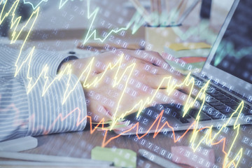Multi exposure of stock market graph with man working on laptop on background. Concept of financial analysis.