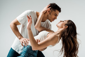 dancers dancing bachata and looking at each other isolated on grey