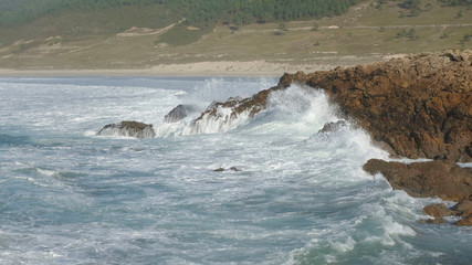 Waves breaking against the cliffs. Nemiña beach, in Atlantic Galician Coast, Spain.
