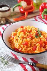Italian cuisine. Plate of red bell pepper risotto