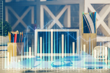 Double exposure of chart and financial info and work space with computer background. Concept of international online trading.