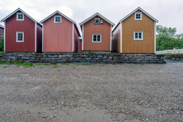 Old wooden building on the beach in the city of Mosjoen in Northern Norway during rainy weather. Architecture, landscape near me and travelocity concept.