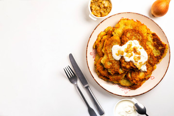 Exposition of home made potato pancakes on white table, traditional tasty food.
