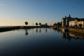 Fototapeta premium Galway city at sunrise - taken from the Claddagh, showing the harbor and buildings on a clear morning by the River Corrib
