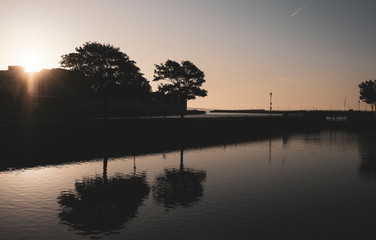 Galway city at sunrise - taken from the Claddagh, showing the harbor and buildings on a clear morning by the River Corrib