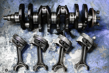 crankshaft and pistons with connecting rods on the table