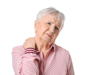 Senior woman suffering from neck pain on white background