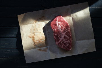 Fresh raw beef angus steak on brown paper