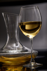 A glass full of wine and wine decanters