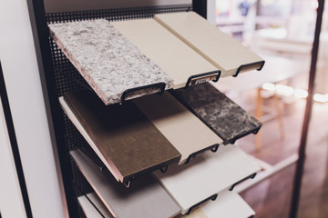 home furnishing store demonstrating variants of stone for kitchen countertop.