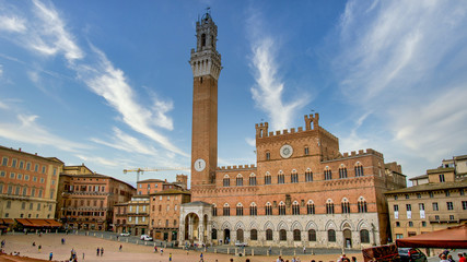 Siena, Toscana, Italy - November 2019: Siena clock tower in Siena square Basilica Cateriniana di San Domenico - obrazy, fototapety, plakaty