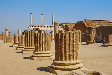 Ancient city Pompeii with arches, forum, columns, houses and streets. Ruins of Roman city destroyed by the eruption of volcano, Mount Vesuvius. Naples, Italy. Popular Italian travel destination.