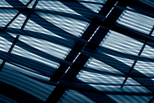 Digitally rendered image of modern architecture with hi-tech transparent glass grid panels of roof or ceiling. Contrast abstract geometric background with irregular pattern in shades of blue color.