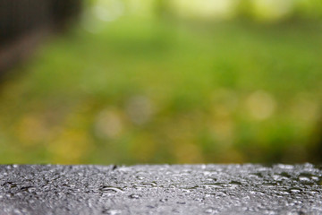 Wood floor with blurred trees of nature park background and summer season,
