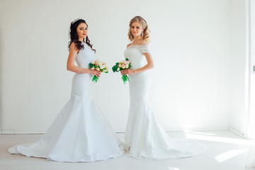 Fototapeta na wymiar two wedding bride with bouquet wedding hairstyle
