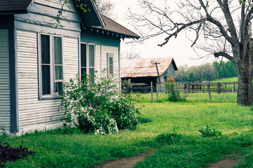 Abandoned Texas farm house with barn.