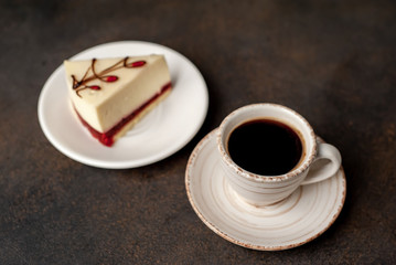 Coffee and tasty cheesecake on a plate on a stone background , breakfast concept