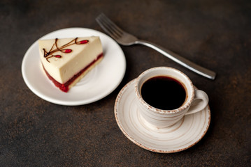 Coffee and tasty cheesecake on a plate on a stone background , breakfast concept