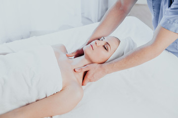 Obraz na płótnie Canvas doctor cosmetologist doing facial massage girl spa treatments