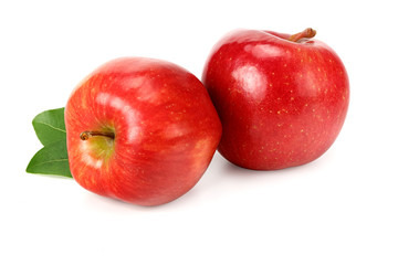 two red apples with green leaves isolated on white background