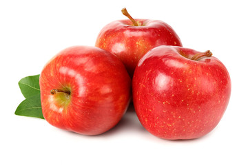 three red apples with green leaves isolated on white background