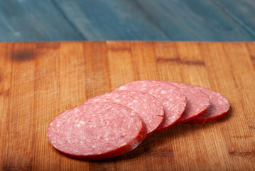 slicing sausage on a cutting Board
