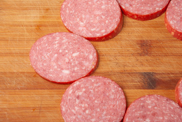 slicing sausage on a cutting Board
