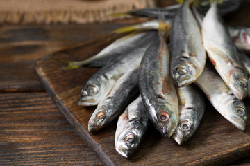Fresh mackerel fish on wooden Board on brown wooden background