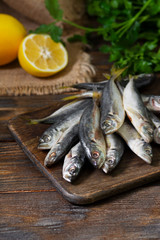 Fresh mackerel fish on wooden Board on brown wooden background	