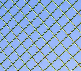 Fototapeta premium Metal mesh against the blue sky.