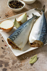 Fresh raw fish. Mackerel and ingredients for cooking on a stone countertop. Copy space.