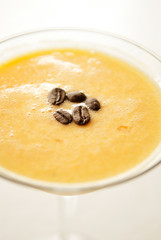 Coffee beans as garnish with yellow cocktail glass