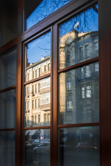 Building reflects in the window in an old building