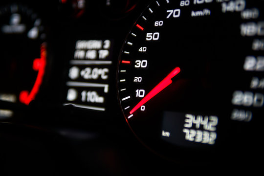 Close up shot of a speedometer in a car. Car dashboard. Dashboard details with indication lamps.Car instrument panel. Dashboard with speedometer, tachometer, odometer. Car detailing.