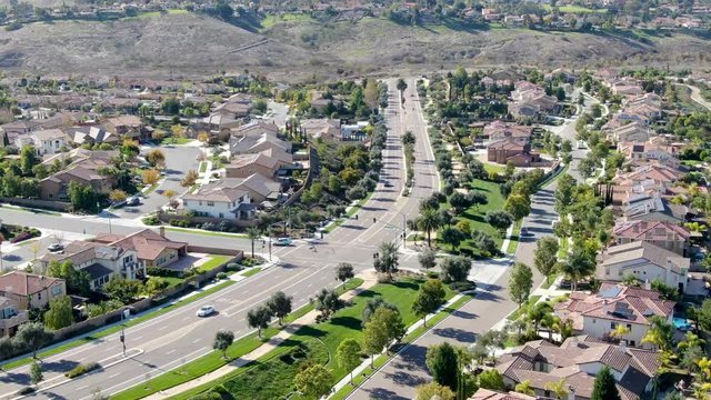 Aerial view of neighborhood with residential modern subdivision luxury houses and small road during sunny day in Chula Vista, California, USA.